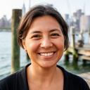Shauni Toall smiling beside a fishing dock in New York City
